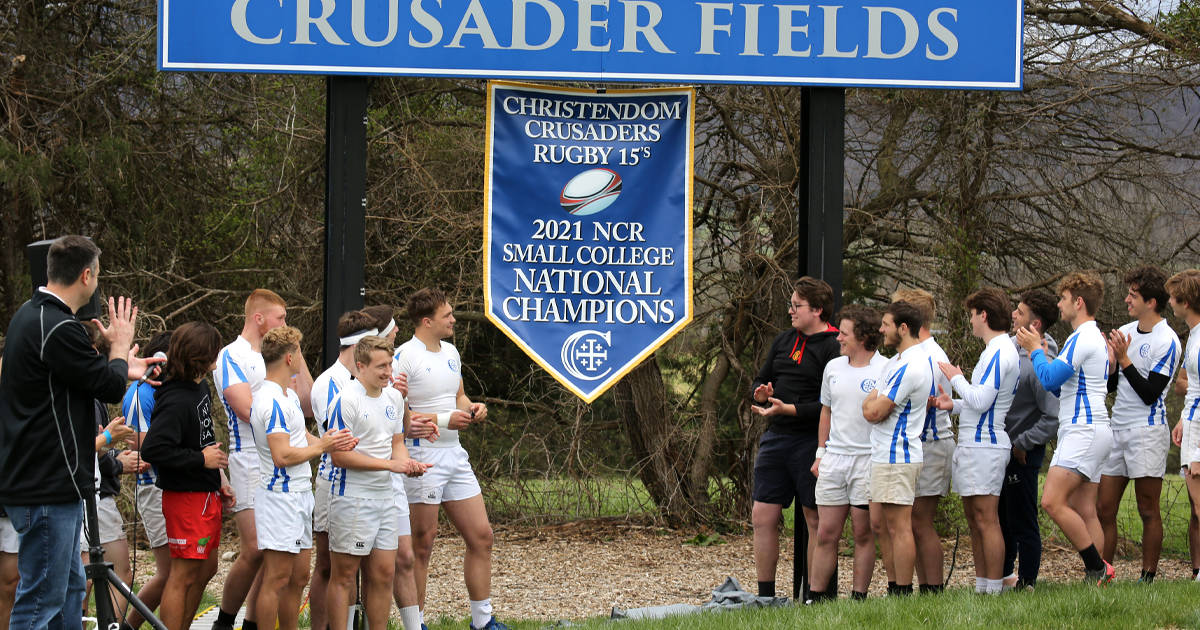 The college unveiled the 2021 National Championship banner for the men's rugby team during the 2022 Crusader Alumni Games.