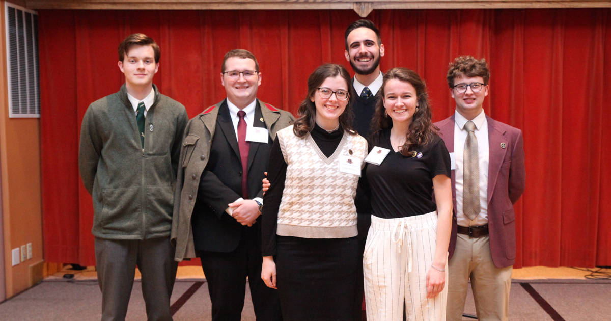 Six members of Christendom's Chester-Belloc Debate Society.