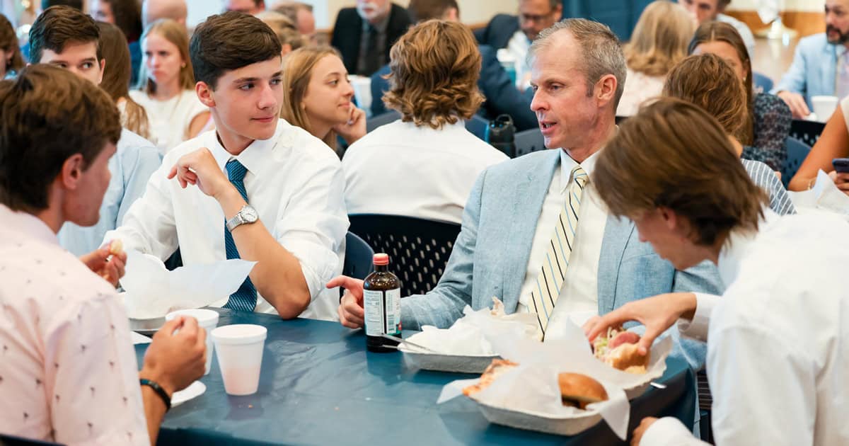 Dr. John Cuddeback has lunch with students in the Commons, sharing his wisdom and encouraging their questions.
