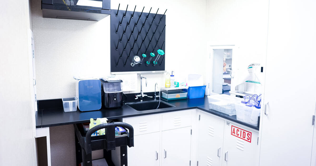 The labs are connected by a shared prep room that allows materials and lab trays to move efficiently between instructional and preparation spaces.