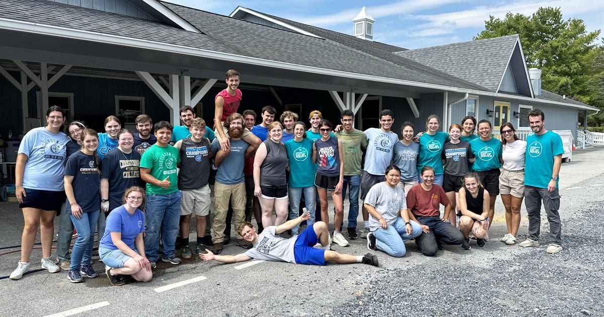 Students smile outside John Paul the Great Montessori Academy after the completion of the first Omnia service project.